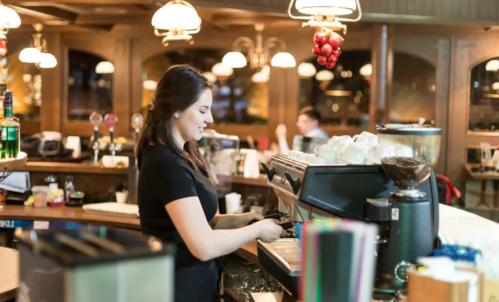 Coffee shop equipment and barista at work